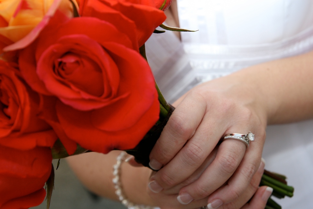 Image of bride's hands featuring her rings and her bouquet
