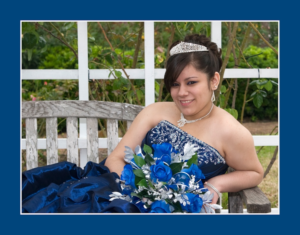 Quinceanera Portrait of young girl in royal blue dress reclined