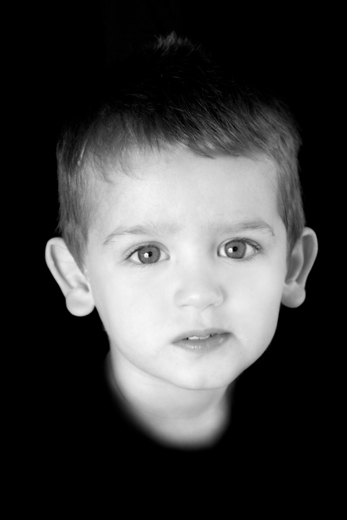 Serious expression in little boy's formal portrait