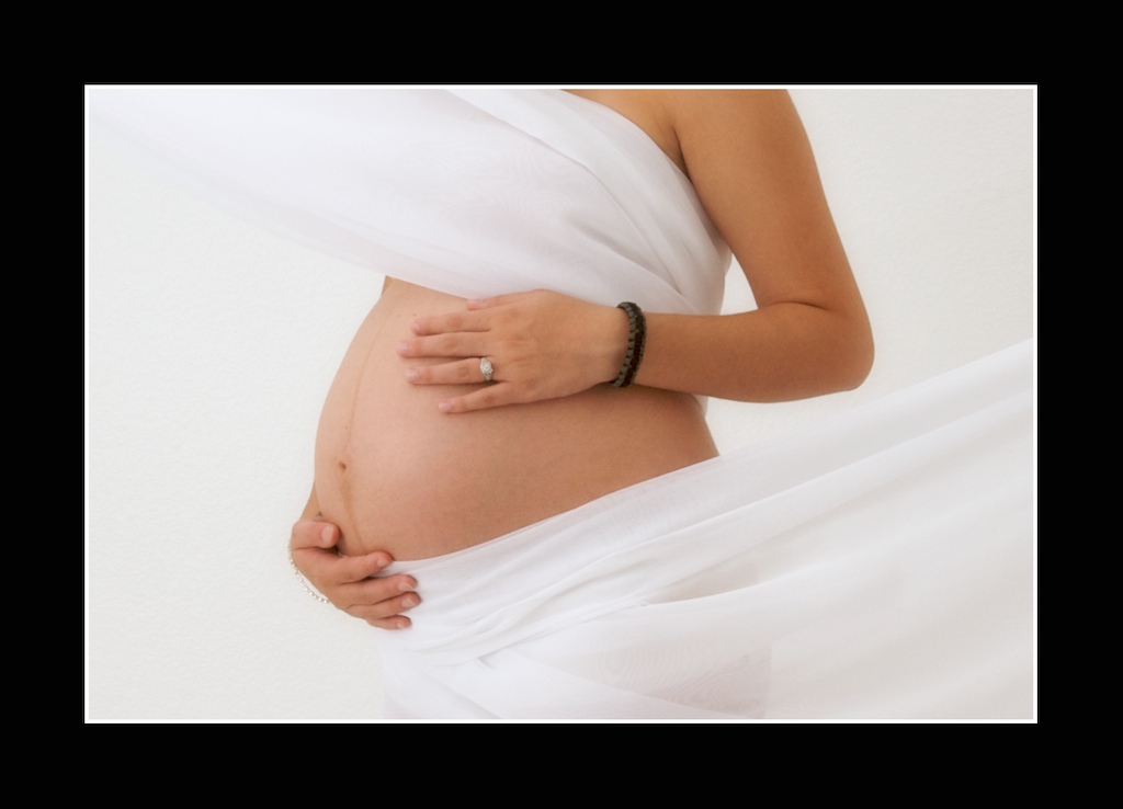 Bare Belly draped in white. no face shown. Color Image